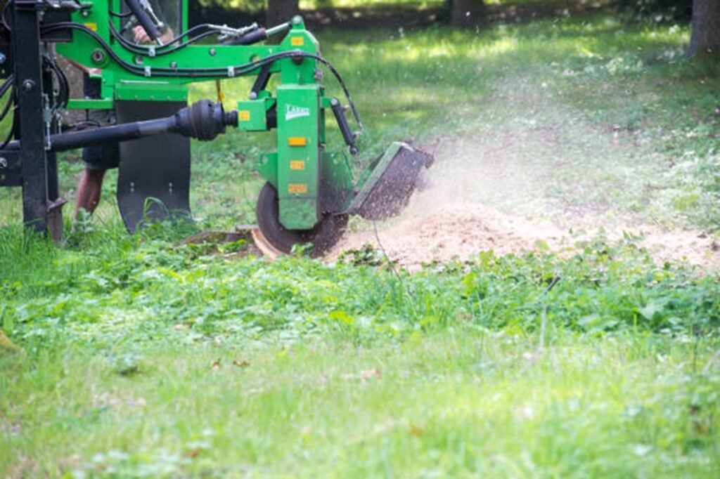 Professional stump grinding machine removing a tree stump below ground level during stump grinding and removal service in Chesterfield, MO.